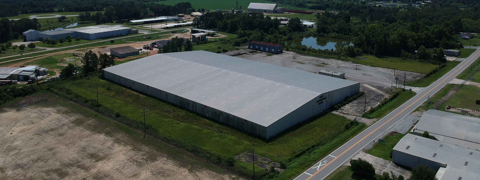 warehouse next to a small pond